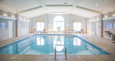 Indoor swimming pool area with lounge chairs
