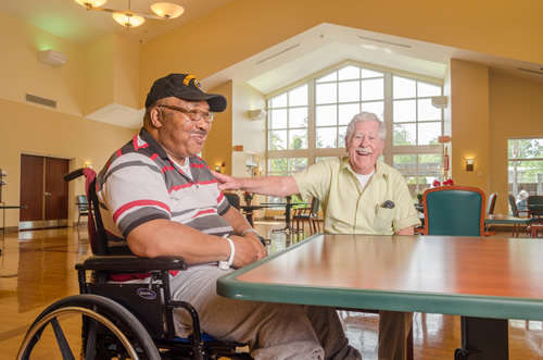 Two residents enjoying conversation in a common area