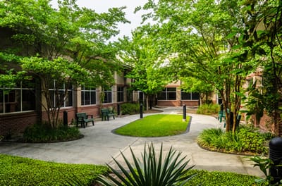 Well-maintained outdoor garden area with seating