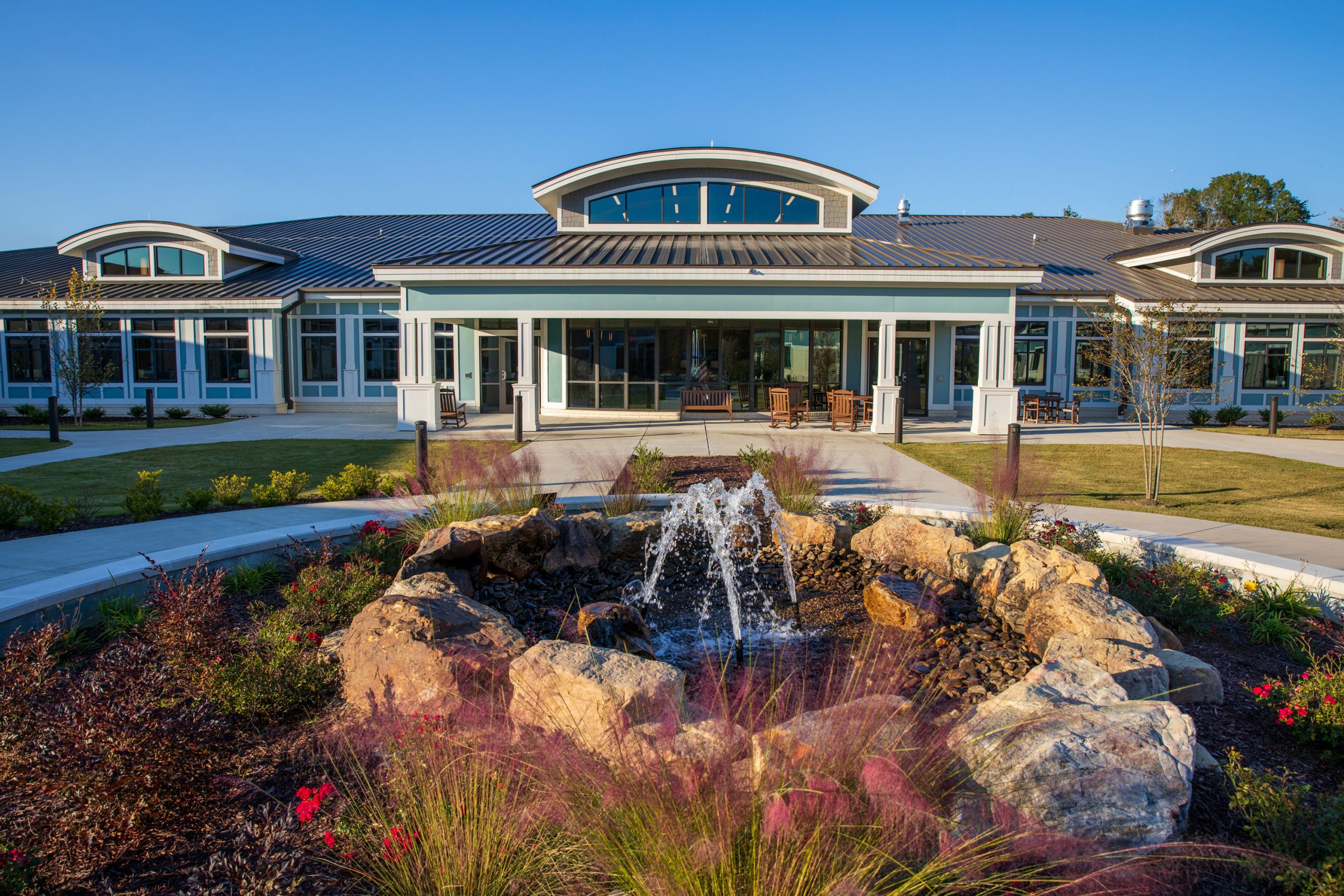 Exterior view of the facility with a fountain and garden