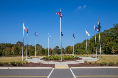 Outdoor area with flagpoles and landscaped garden