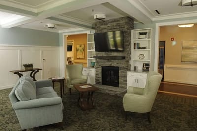 Cozy interior common area with seating and fireplace