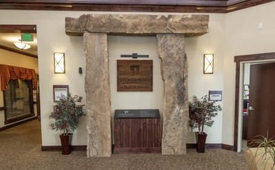 Interior lobby area with stone feature and signage