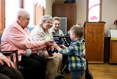 Children interacting with residents during a group activity