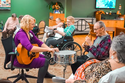 Residents enjoying a music activity in a common area