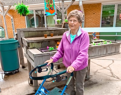 Resident enjoying the garden area with a walker