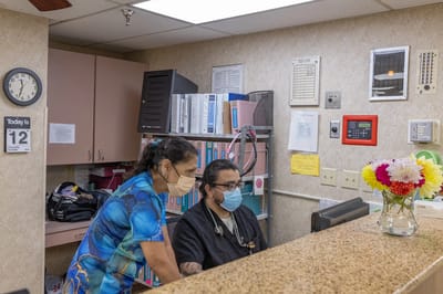 Staff assisting a resident at the front desk