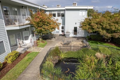Outdoor courtyard with seating and a pond