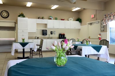 Dining area with tables and flower arrangements