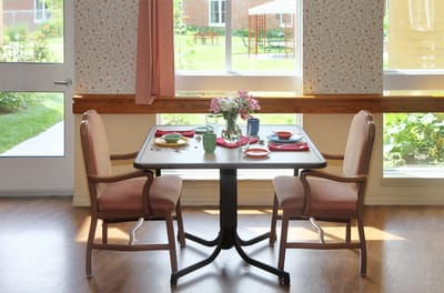 Dining room table set for a meal with a view of the garden