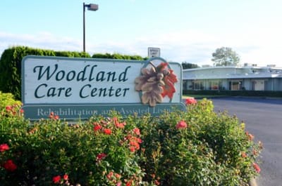 Exterior view of Woodland Care Center with signage