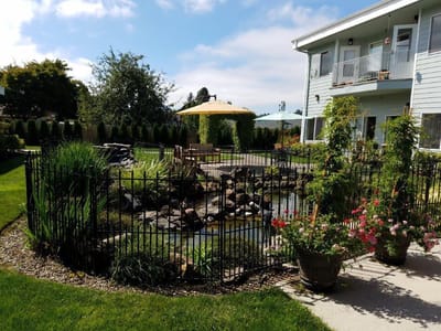 Outdoor garden area with pond and flowers