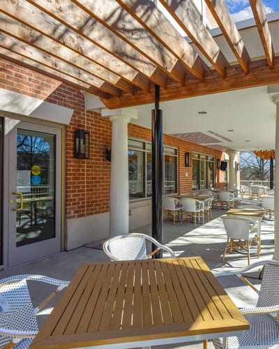 Outdoor patio area with seating and wooden overhang