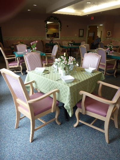 Dining area with set tables and floral centerpieces
