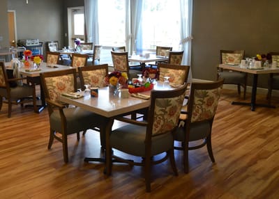 Bright dining room with flowers on tables