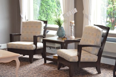 Cozy chairs arranged by a window in a common area