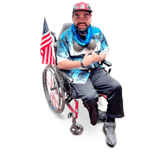 St Ann Center for Intergenerational Care, memory care in Milwaukee, WI — Man in wheelchair with American flag and colorful shirt