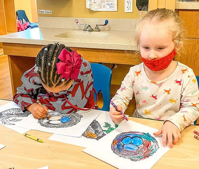 Children engaging in art activity at a table