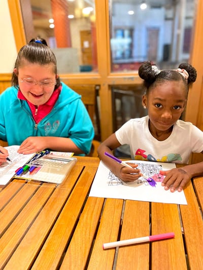 St Ann Center for Intergenerational Care, memory care in Milwaukee, WI — Children coloring together at a wooden table