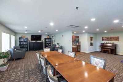 Bright common area with seating and piano
