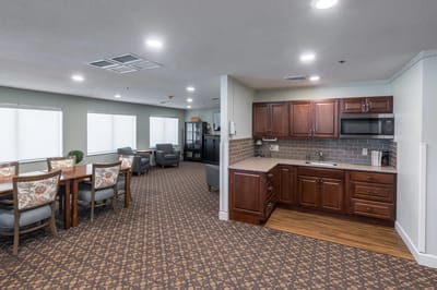 Interior view of a common area with seating and kitchenette