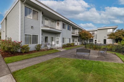 Exterior view of the assisted living facility with gardens