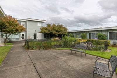 Outdoor seating area with landscaped garden near building