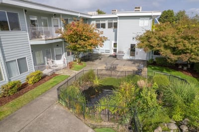 Outdoor courtyard with pond and seating area