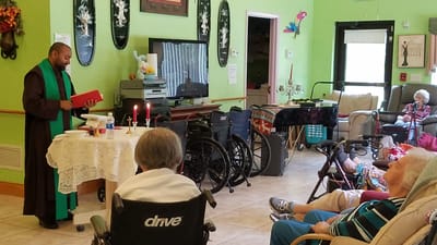 Residents gathered for a spiritual service in a common area