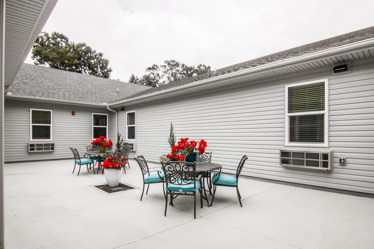 Outdoor seating area with flowers and tables