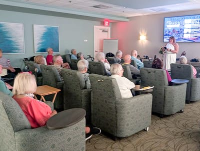 Residents enjoying a presentation in a common area