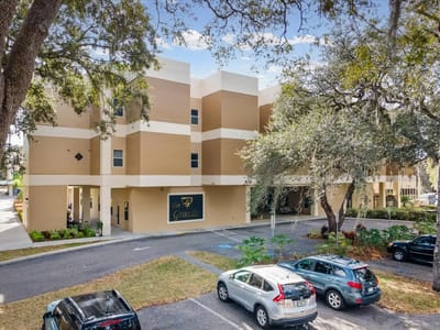 Exterior view of The Grande Senior Living building with parking lot