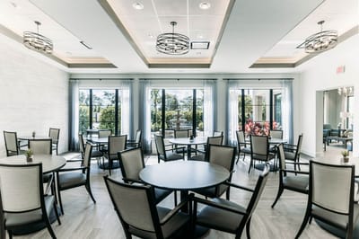 Bright dining room with circular tables and large windows