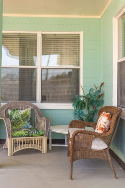 Outdoor seating area with wicker chairs and plants