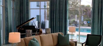 Lounge area with a view of the pool and grand piano