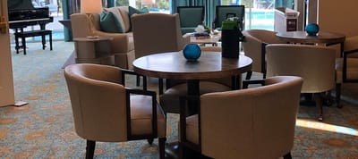 Interior common area with seating and a view of the pool
