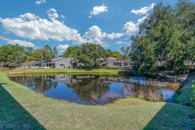 Outdoor view of facility grounds by a pond