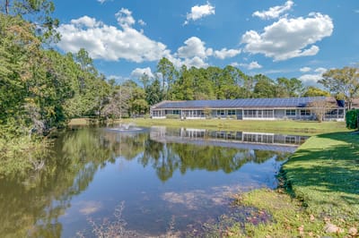 The exterior of Wyndham Lakes Jacksonville near a pond