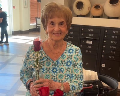 Resident holding roses in a common area