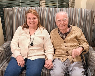 Residents enjoying time together on a sofa