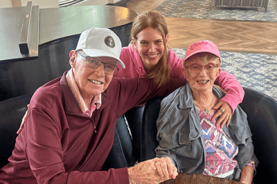 Residents enjoying time with staff in a cozy lounge