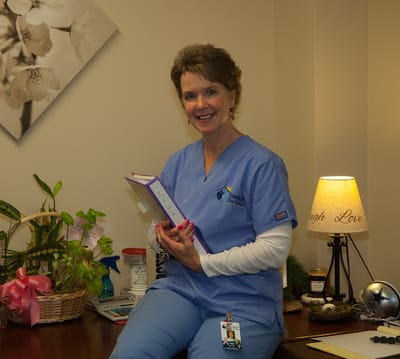 A staff member smiling in an interior space