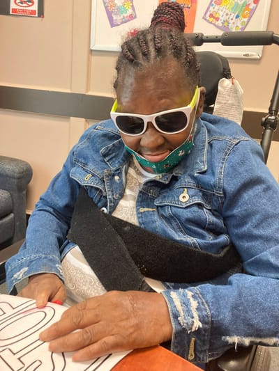 Resident participating in an indoor activity with art supplies