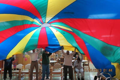 Residents engaging in a colorful group activity indoors