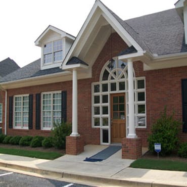 Jonesboro Adult Health & Day Support, Nursing Home — Entrance of a brick building with decorative windows