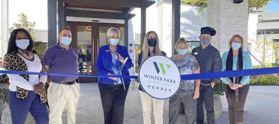 Ribbon-cutting ceremony with staff and members