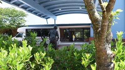 Entrance view with greenery and facility shuttle van