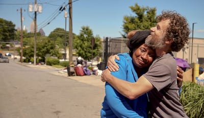 Two people embracing in an outdoor space