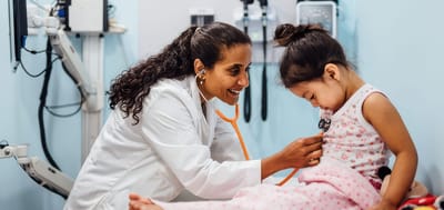 Child receiving a check-up from a doctor