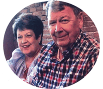 Perfect Care, nursing home in Americus, GA — Smiling elderly couple sitting together at a table